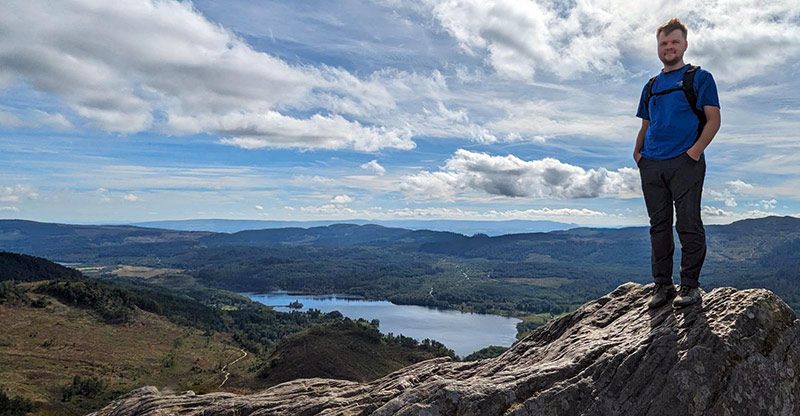 Callum Wrathall on a hilltop.