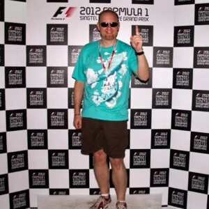 Gordon poses in front of a Formula 1 even stand in 2012