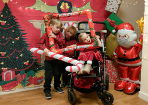 Rose and her brothers at the Cerebral Palsy Scotland Christmas party
